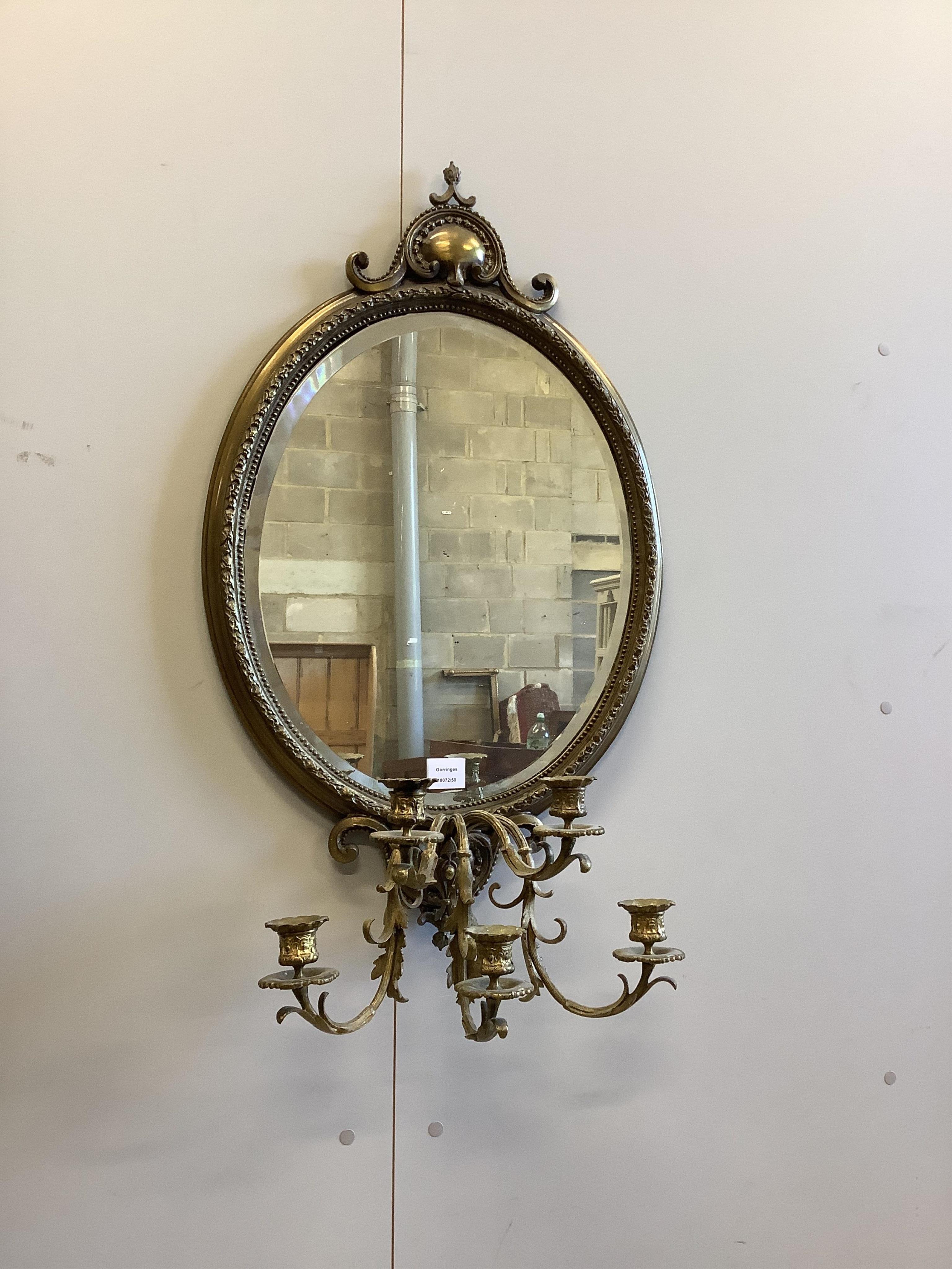 An early 20th century oval brass girandole wall mirror, width 52cm, height approx. 90cm